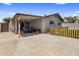 Covered patio features a ceiling fan and a table set, perfect for outdoor dining and entertaining at 901 E Hearn Rd, Phoenix, AZ 85022