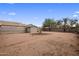Spacious backyard featuring gravel and mature trees, provides a blank canvas for landscaping and outdoor activities at 901 E Hearn Rd, Phoenix, AZ 85022