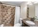 Bathroom with a tile shower and a dark vanity with unique sink and faucet at 901 E Hearn Rd, Phoenix, AZ 85022