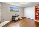 Bedroom with wood floors, window, double door closet, and orange shelving at 901 E Hearn Rd, Phoenix, AZ 85022