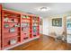 Bedroom with orange shelves, a school desk, and wood floors at 901 E Hearn Rd, Phoenix, AZ 85022