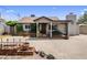 Charming single-story home featuring a quaint front porch and well-manicured landscaping at 901 E Hearn Rd, Phoenix, AZ 85022