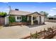 Charming home with brick accents and lush greenery enhancing the curb appeal and cozy front porch at 901 E Hearn Rd, Phoenix, AZ 85022