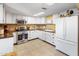 Bright kitchen featuring white cabinets, stainless steel appliances, and modern countertops at 901 E Hearn Rd, Phoenix, AZ 85022