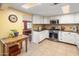 Well-lit kitchen with white cabinetry, stainless steel appliances, and a breakfast nook at 901 E Hearn Rd, Phoenix, AZ 85022