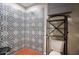 Bathroom featuring patterned tile wall, toilet, storage rack and metal hooks at 921 W Willetta St, Phoenix, AZ 85007