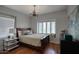 Comfortable bedroom showcasing a bay window, hardwood floors, and elegant lighting at 921 W Willetta St, Phoenix, AZ 85007