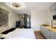 Bedroom featuring a modern light fixture, zebra art, spiral staircase and kitchenette at 921 W Willetta St, Phoenix, AZ 85007