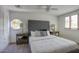 Cozy bedroom featuring a tufted headboard and ample natural light from the window at 921 W Willetta St, Phoenix, AZ 85007