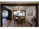 A view of the dining room open to the living room and kitchen featuring exposed beams and hardwood floors at 921 W Willetta St, Phoenix, AZ 85007
