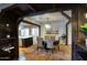 Elegant dining room featuring hardwood floors, exposed beams and a modern chandelier at 921 W Willetta St, Phoenix, AZ 85007