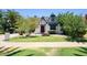 Charming Tudor-style home features a well-manicured lawn, mature trees, and a unique water fountain feature at 921 W Willetta St, Phoenix, AZ 85007