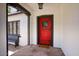A close-up of the red front door to the Tudor home and the front porch at 921 W Willetta St, Phoenix, AZ 85007