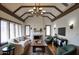 Inviting living room showcasing a cozy fireplace, exposed beams, and an abundance of natural light at 921 W Willetta St, Phoenix, AZ 85007