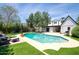 Beautiful backyard with a large pool, a patio area, and lush landscaping creating a private oasis at 921 W Willetta St, Phoenix, AZ 85007
