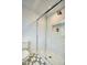 Modern shower with white subway tile surround, glass door, and patterned tile floor at 921 W Willetta St, Phoenix, AZ 85007