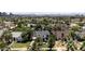 Street view featuring the Tudor-style home surrounded by mature trees and lush greenery at 921 W Willetta St, Phoenix, AZ 85007