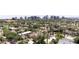 Street view showcasing a charming neighborhood with lush greenery, palm trees, and a cityscape backdrop at 921 W Willetta St, Phoenix, AZ 85007