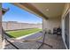 Relaxing backyard featuring a hammock, patio, and low-maintenance artificial grass at 94 S 189Th Ln, Buckeye, AZ 85326