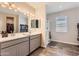 Bathroom featuring dual sinks, tiled shower and a separate toilet at 94 S 189Th Ln, Buckeye, AZ 85326