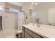 Bright bathroom with a floral shower curtain, light fixtures, and a large mirror at 94 S 189Th Ln, Buckeye, AZ 85326
