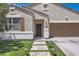 Inviting home with stone pathway, artificial grass, and a welcoming front door at 94 S 189Th Ln, Buckeye, AZ 85326