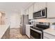 Updated kitchen featuring stainless steel appliances and grey cabinetry at 94 S 189Th Ln, Buckeye, AZ 85326