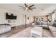 Open-concept living area with tile flooring, ceiling fan, and ample natural light at 94 S 189Th Ln, Buckeye, AZ 85326