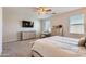 Large bedroom with dresser, vanity, ceiling fan and lots of natural light at 94 S 189Th Ln, Buckeye, AZ 85326