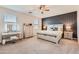 Bedroom featuring an accent wall, ceiling fan and lots of natural light at 94 S 189Th Ln, Buckeye, AZ 85326
