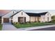 Beautiful two-story home with a stone accent, a manicured lawn, a paver driveway, and a three-car garage at 9801 N 53Rd Pl, Paradise Valley, AZ 85253