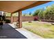 Covered patio overlooking a lush backyard with beautiful desert views creating a relaxing outdoor space at 10399 E Hillery Dr, Scottsdale, AZ 85255