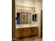 Bathroom with a double vanity, a large mirror, and a view of the shower at 10399 E Hillery Dr, Scottsdale, AZ 85255