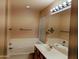 Bright bathroom with a bathtub, a double vanity, a mirror, and a towel rack on the wall at 10399 E Hillery Dr, Scottsdale, AZ 85255