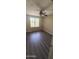 Well-lit bedroom featuring a ceiling fan, wood-look floors, and a window overlooking the outside at 10399 E Hillery Dr, Scottsdale, AZ 85255