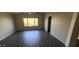 Spacious bedroom with a view of the large window, dark wood-look floors, and a walk-in closet at 10399 E Hillery Dr, Scottsdale, AZ 85255