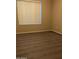 Bedroom featuring laminate flooring and a window with a blind at 10399 E Hillery Dr, Scottsdale, AZ 85255