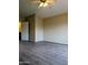 Tan bedroom with a ceiling fan, wood-look floors, and a view of the doorway to another room at 10399 E Hillery Dr, Scottsdale, AZ 85255
