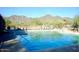 Community pool with lounge chairs and mountain views offers a refreshing retreat and social gathering space at 10399 E Hillery Dr, Scottsdale, AZ 85255