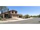 Charming two-story home featuring a two-car garage and desert landscaping at 10399 E Hillery Dr, Scottsdale, AZ 85255