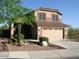 Charming two-story home featuring a two-car garage and desert landscaping at 10399 E Hillery Dr, Scottsdale, AZ 85255