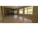 Open-concept living room with large windows and seamless access to the modern kitchen at 10399 E Hillery Dr, Scottsdale, AZ 85255