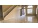 Spacious living room featuring tile flooring, arched windows, and an open entryway at 10399 E Hillery Dr, Scottsdale, AZ 85255
