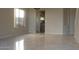 Spacious living room featuring tile flooring and an open entryway to the kitchen at 10399 E Hillery Dr, Scottsdale, AZ 85255