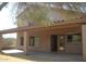 Covered patio area with sliding glass doors and ample space for outdoor relaxation and entertainment at 10399 E Hillery Dr, Scottsdale, AZ 85255