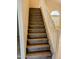 Staircase featuring wood treads and white railing leading upstairs at 10399 E Hillery Dr, Scottsdale, AZ 85255