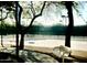 Community tennis court with benches and shade trees, providing a recreational amenity for active residents at 10399 E Hillery Dr, Scottsdale, AZ 85255