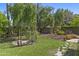 Landscaped backyard featuring a charming gazebo, lush green lawn, and stone walkway at 1135 W Sea Fog Dr, Gilbert, AZ 85233