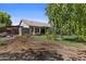 Expansive backyard features a patio, shed, well-maintained lawn, and mature trees offering privacy and tranquility at 1135 W Sea Fog Dr, Gilbert, AZ 85233