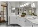 Well-lit bathroom featuring dual sinks, ample countertop space, and modern fixtures with dark tile floors at 1135 W Sea Fog Dr, Gilbert, AZ 85233